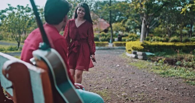 A couple reunion in a park, a girl apologizing for being late to her boyfriend, an emotional love story showing patience, forgiveness, and affection in nature