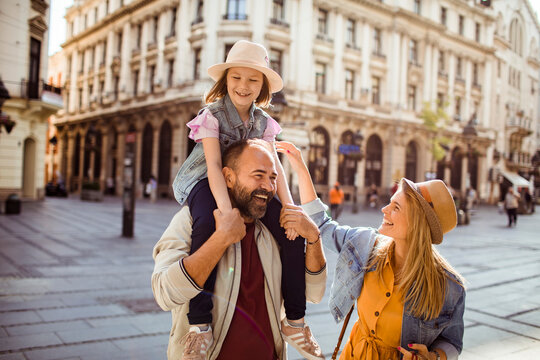 Smiling family sightseeing in historic european city