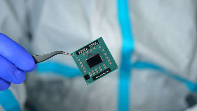 AMD CPU in hand of developer, concept of semiconductor and microchips shortage along with sanctions, critical mineral embargo and rear earth mining: Toronto, Ontario, Canada - March 24, 2026