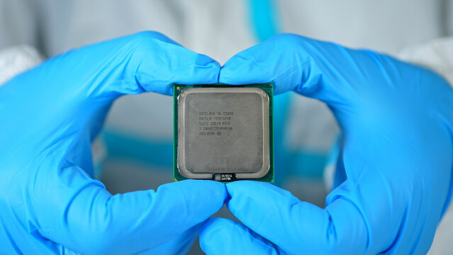 Scientists or engineer shows Intel CPU Central Processing Unit in the hand. Concept of AI boom triggered a massive shortage of CPUs, driving prices high: Toronto, Ontario, Canada - March 24, 2026