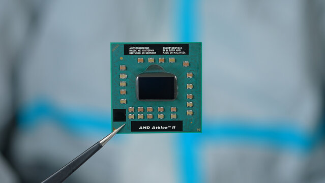 AMD CPU in hand of developer, concept of semiconductor and microchips shortage along with sanctions, critical mineral embargo and rear earth mining: Toronto, Ontario, Canada - March 24, 2026