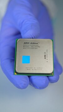 AMD CPU in hand of developer, concept of semiconductor and microchips shortage along with sanctions, critical mineral embargo and rear earth mining: Toronto, Ontario, Canada - March 24, 2026