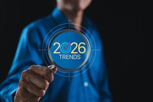 2026 trends target market research and future business insight concept. Person holding magnifying glass over 2026 target. trend analysis, market forecasting, strategic planning, opportunity discovery