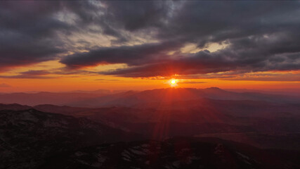 Fototapeta premium Sunset over mountain with dramatic clouds