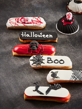 These decorated Halloween desserts feature eerie designs and vibrant colors, perfect for festive gatherings. Ideal for use in marketing campaigns, party planning, and bakery menu displays