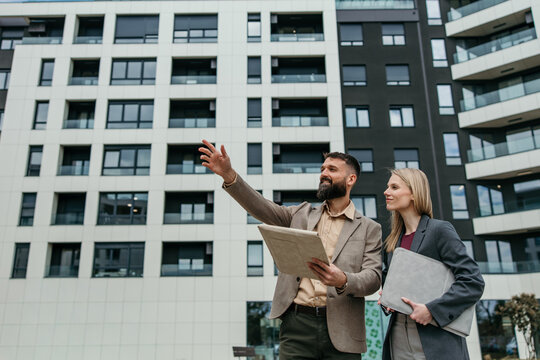 Real estate agents discussing property investment opportunities