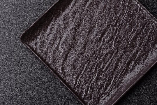 A blank slate board on a dark background for Asian food. A blank slate board