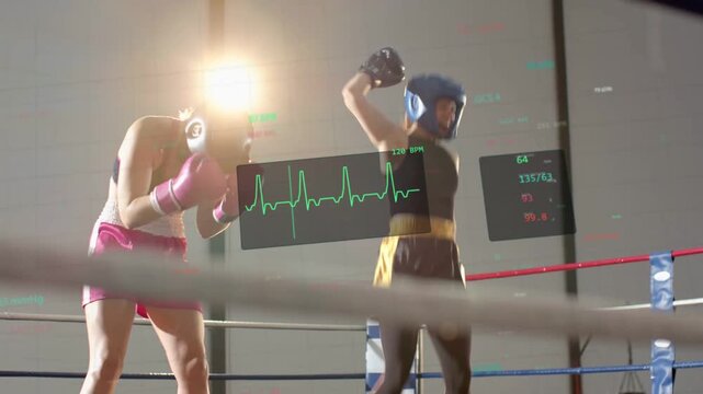 Blue boxer raising arm signaling win, causing coach entering ring, lifting arm, ECG behind fighters