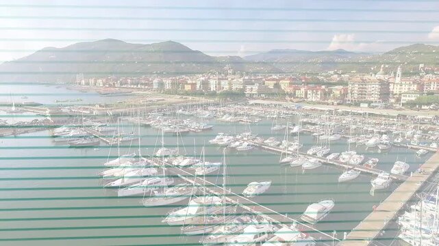 Operator-triggered drone panning to showcase marina rows and diagonal pier through blinds