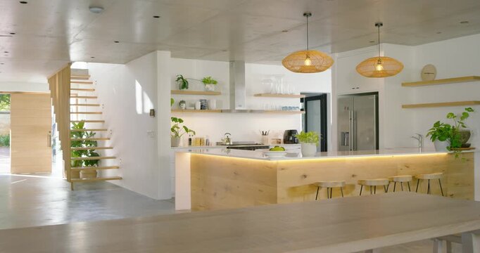 Camera is sliding forward, bringing wooden kitchen island into frame to showcase LED lighting