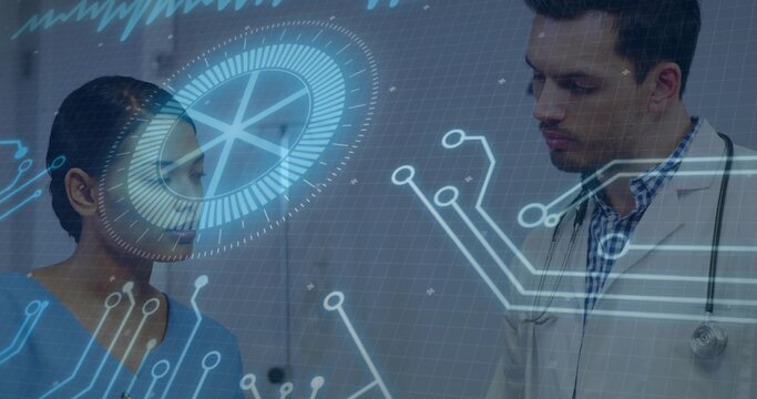 Examining doctor and nurse wearing white coat, blue scrubs in clinic with stethoscope and HUD