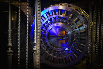 Fototapeta premium photo of a large bank vault in blue lighting 