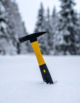 Yellow Handle Hammer Stuck In Snowy Forest.