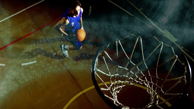 Basketball player dribbling overhead-left, starting drive toward rim, launching, scoring to finish