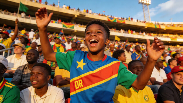 Cheering child wearing colorful DR jersey raising arms at stadium stands, with flags and floodlight