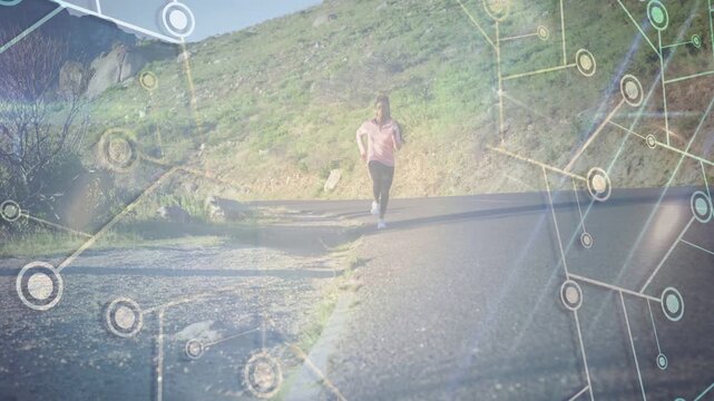 Female runner walking then jogging toward camera on hill road, with tech overlay tracking runner