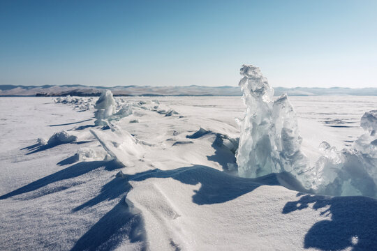 Winter Landscape Shows Ice Formations on a Lake Under a Clear Sky During a Sunny Day in a Cold Region