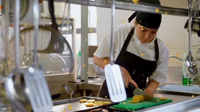 Female chef positioning roll, slicing on green board in kitchen, stars marking rounds for baking