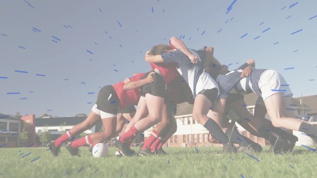 Male rugby scrum tightening bind and driving on grass, contesting ball, blue streaks tracing legs