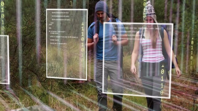 Male and female hikers walking pine trail movement activating tech code panels visualizing data