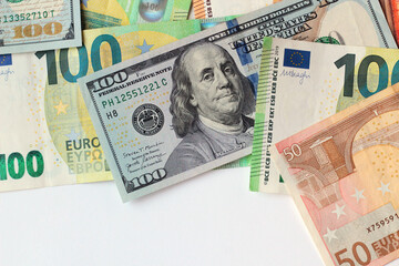 Obraz premium American dollar banknotes designed on white surface with Euro banknotes and copy space