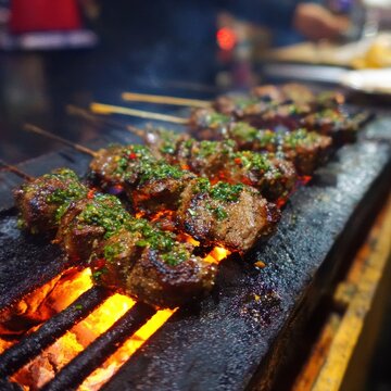 Authentic Peruvian Anticuchos Skewers Grilled at Night Market in Lima with Aj&iacute; Panca Marinade