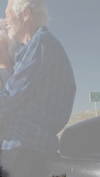 Vertical video: Senior couple leaning, animated flower appearing on trunk, evoking travel memory