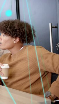 Vertical video: Man reacting to offframe cue in meeting, turning with cup as cyan lines obscuring