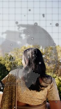 Vertical video: Woman on terrace turning left, starting globe and grid shifting over head for tech