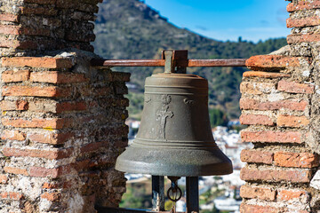 Fototapeta premium Bell at old castle Castillo del Aguila at white town Gaucín, Málaga province, Spain