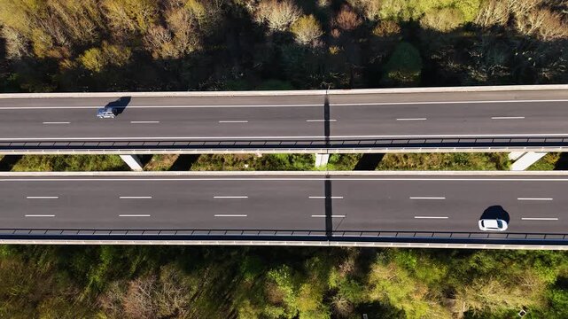 Top down aerial view of cars driving on highway viaduct