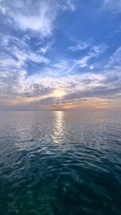 Obraz premium Adriatic Sea reflecting golden sunset over calm waters along Montenegro coast