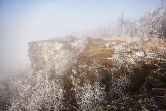 Foggy sandstone cliff near Decinsky Sneznik