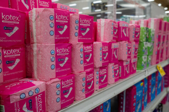 Villa de Alvarez, Colima. Mexico. April 14, 2026: Brightly Lit Store Shelf Display of Pink Packaged Kotex Panty Liners and Feminine Hygiene Products