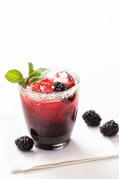 Red fruity cocktail on white background