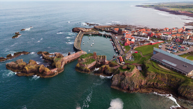 Top view of historic Dunbar Harbour and coastal town layout along the North Sea shore in East Lothian Scotland
