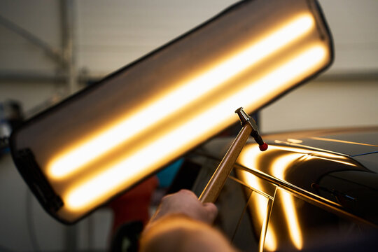 Paintless dent removal requires dynamic metal massaging using targeted knockdown strikes.