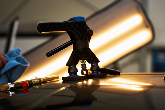 Dynamic glue pulling with a specialized dent lifter gently reverses collision damage from the automotive pillar.