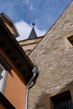 Erfurt / Germany: View from the famous Kraemerbruecke along the corner of two facades to the steeple with ball and cross of the  Aegidienkirche