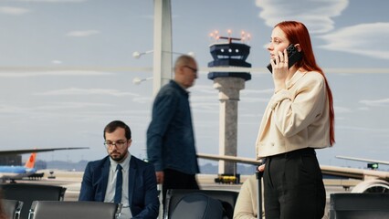 Doing telephone call, airport checkin and woman in lounge going to boarding gate. Walking, crowd...