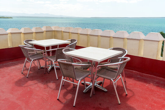Cuba, Cienfuegos.  Cafe tables on rooftop patio, overlooking the Caribbean Sea.