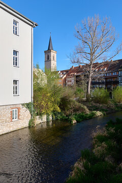 Erfurt / Germany: View from the Kreuzgasse bridge across the Gera river to the famous Kraemerbruecke and the church tower of the Aegidienkirche