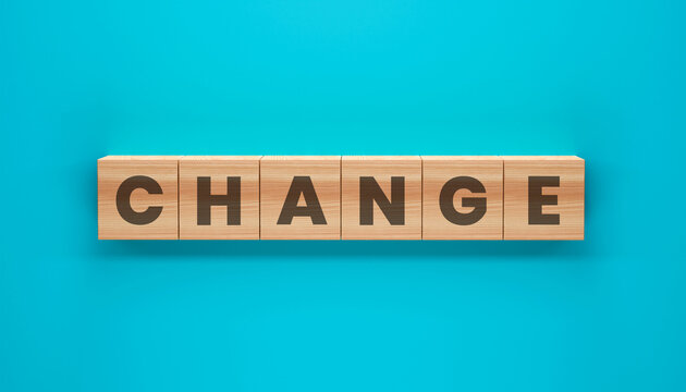 Embracing the Dynamics of Transformation: A visual depiction of the word CHANGE, composed with wooden letter blocks set against a dynamic teal backdrop.