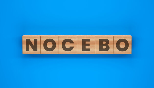 The Power of NOCEBO: The word NOCEBO is displayed on wooden blocks, emphasizing the detrimental impact of negative expectations and beliefs.