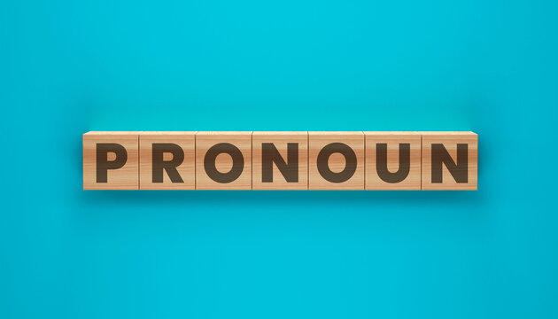 Pronoun Cubes: Wooden blocks spelling out PRONOUN, set against a vibrant turquoise backdrop, forming a visual representation of language and education.