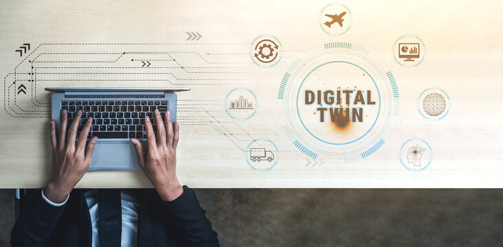 Hands typing on laptop with digital twin concept and technology icons on modern workspace, showcasing the intersection of technology and innovation in business. Quark.