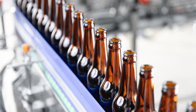 Automated beer bottling line in modern brewery plant, top view
