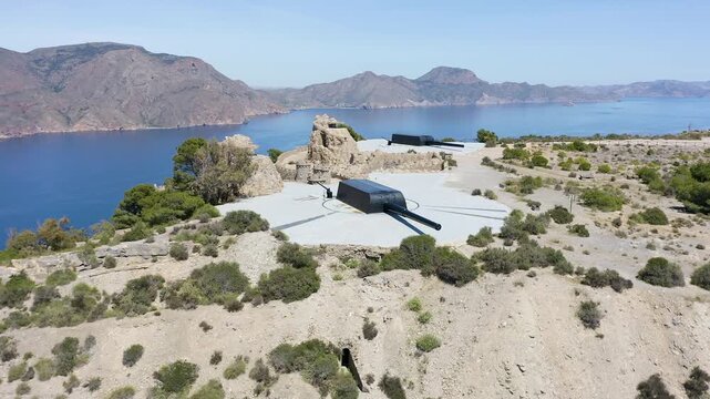 Drone view of the historic Bateria de Castillitos military coastal fortification, featuring the impressive Vickers 381mm naval guns overlooking the Mediterranean Sea in Cabo Ti&ntilde;oso, Spain. 