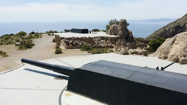 Drone view of the historic Bateria de Castillitos military coastal fortification, featuring the impressive Vickers 381mm naval guns overlooking the Mediterranean Sea in Cabo Ti&ntilde;oso, Spain. 