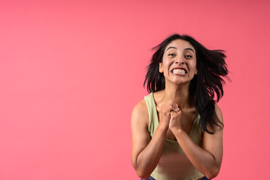 Excited woman celebrating victory with clenched fists